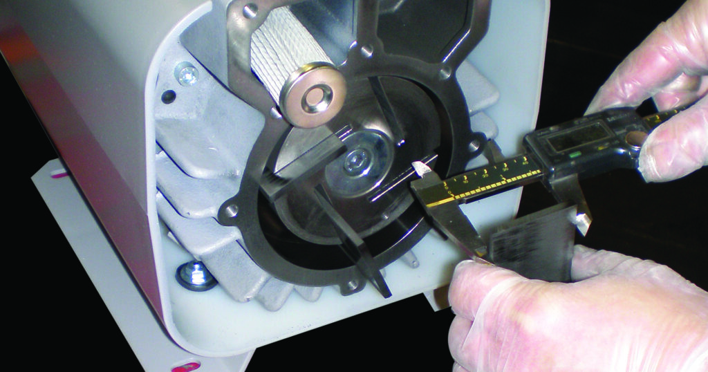 engineer measuring pump with vernier