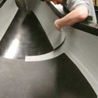 composites man laying carbon fibre sheet for composite applications